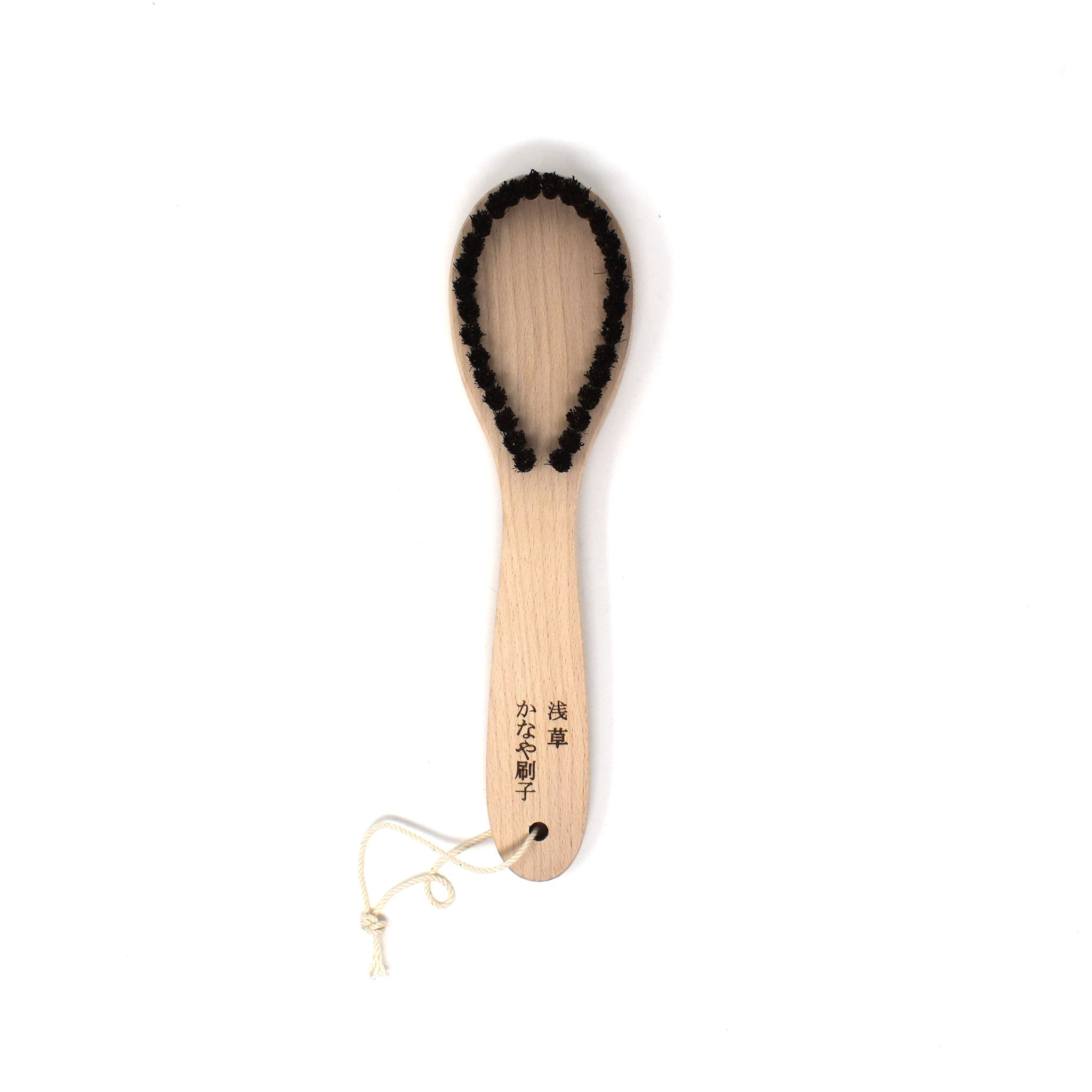 Japanese wooden lint brush with looped bristles for removing lint and pet hair from delicate fabrics, handcrafted in Asakusa by Kanaya Brush.