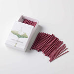 Open box of Hanga Lotus incense with pink Japanese hasu-scented sticks fanned out on a white background, highlighting the packaging and fragrance quantity