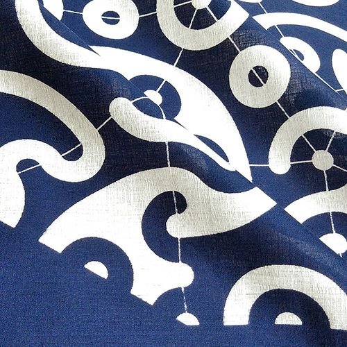 Close-up of indigo Japanese furoshiki fabric with traditional white swirl and circle wave pattern, highlighting the fine weave and print detail.