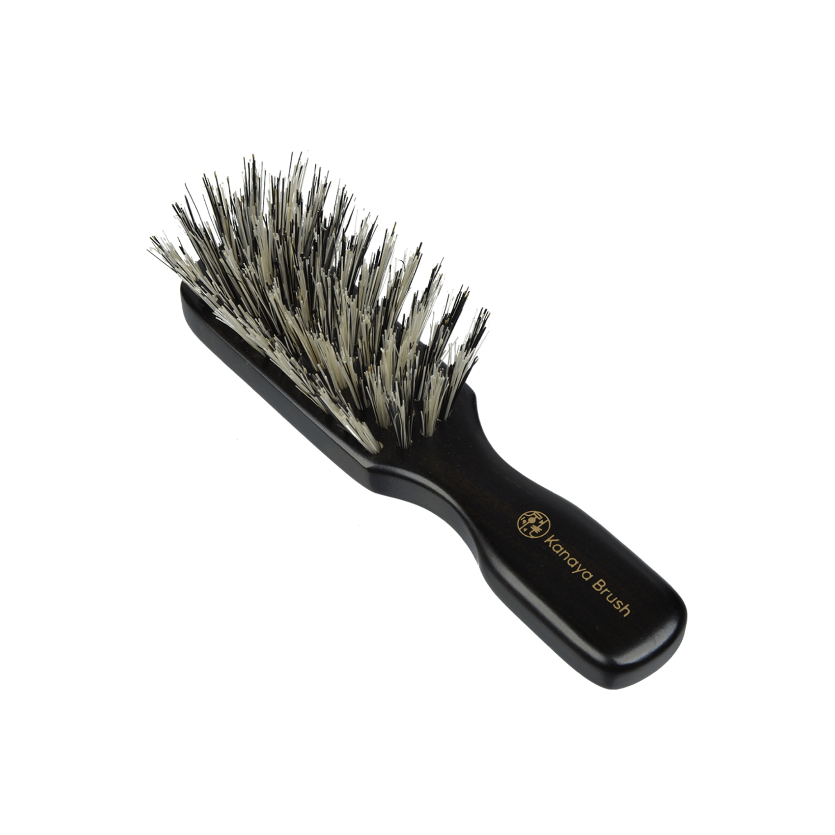 Angled view of the Kanaya Brush travel-size hairbrush with soft boar bristles and a dark wooden handle featuring gold branding. The densely packed bristles help detangle and smooth hair, making it ideal for daily grooming while traveling.