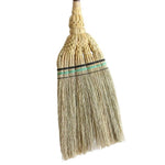 Close-up of the Shirokiya Denbei Edo Broom's head, showcasing intricate straw weaving and decorative black and green binding. Crafted by Japanese artisans, this traditional short-handle broom blends aesthetic beauty with functional design for sweeping hard floors and tatami.