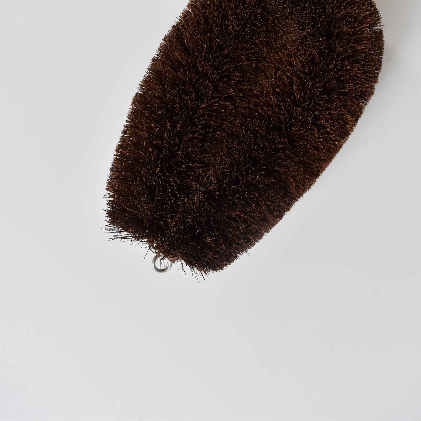 Top view of the extra-large Shuro Tawashi scrubber with visible metal loop and dense coconut fibers.