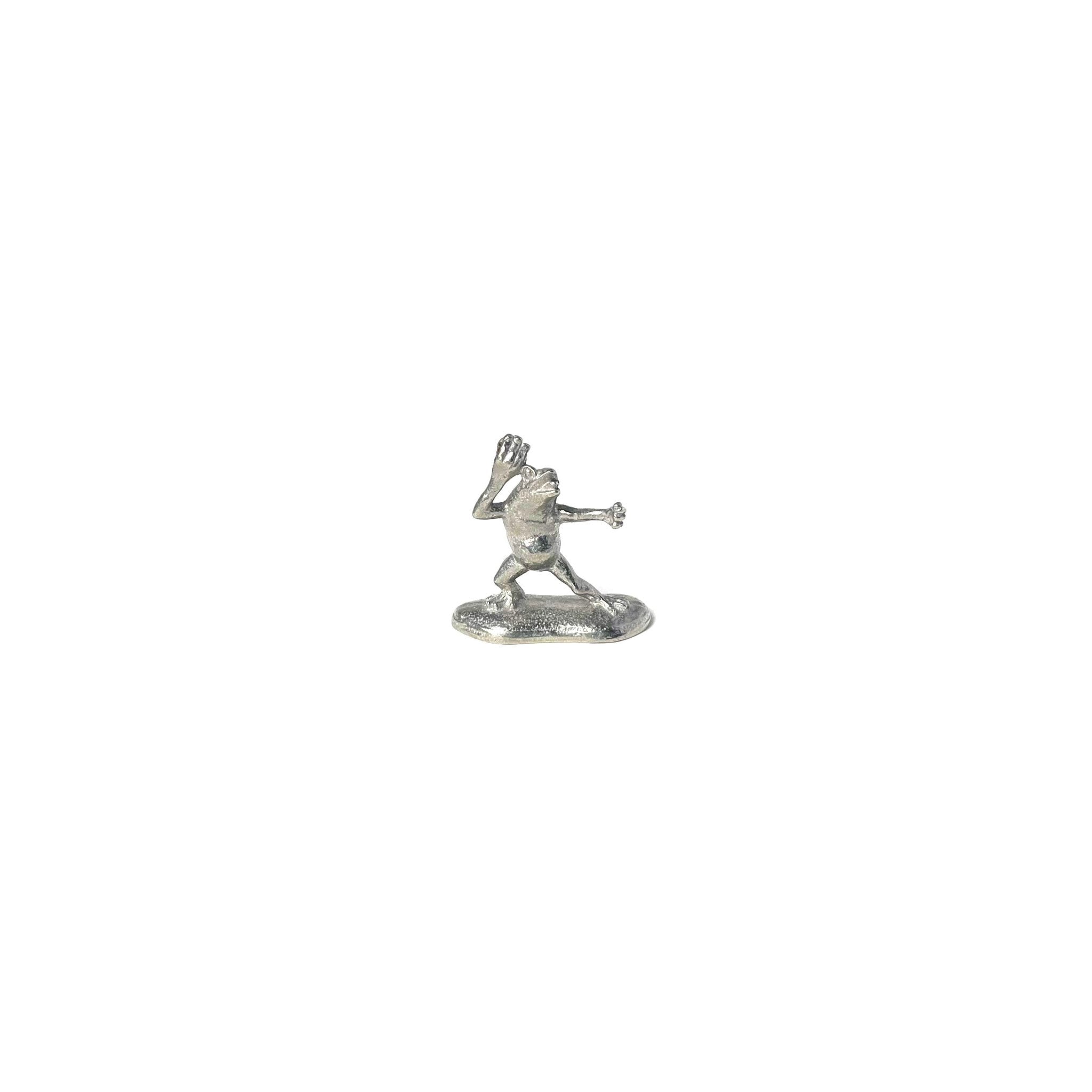 Small pewter incense holder shaped like a frog from the Chōjū-Giga scrolls, mid-pose on a white background.