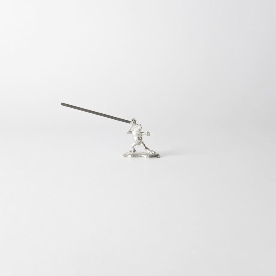 Pewter frog-shaped incense holder from Chōjū-Giga scrolls, holding a lit incense stick in a dynamic pose on a clean white background.