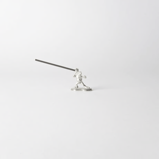 Pewter frog-shaped incense holder from Chōjū-Giga scrolls, holding a lit incense stick in a dynamic pose on a clean white background.