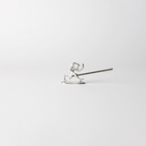 Chōjū-giga monkey-shaped incense holder made from cast tin, holding a lit incense stick in a minimalist white setting – inspired by Japan’s oldest picture scroll.