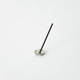 Sakura-shaped pewter incense holder with a stick of incense standing upright in the center, displayed on a white background.
