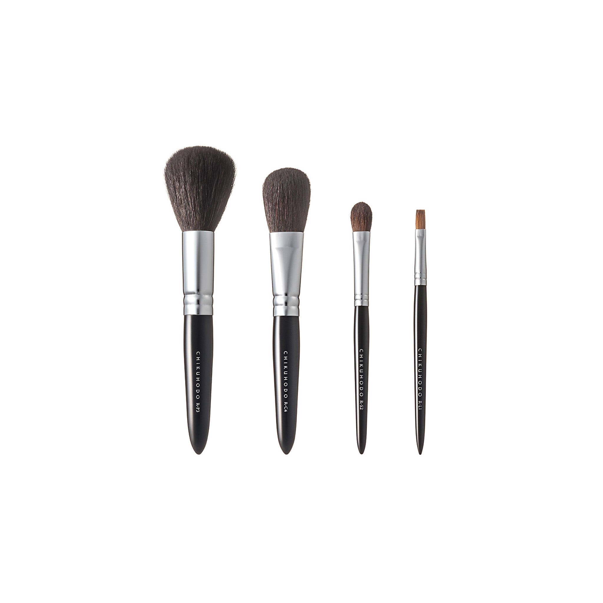 Chikuhodo Japanese makeup brush set with four handcrafted brushes in varying sizes for face and eye application, featuring soft bristles, sleek black handles, and silver ferrules.
