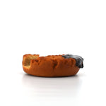 Side profile of a realistic donut-shaped phone holder with a bite mark and glossy chocolate glaze, placed on a clean white background.