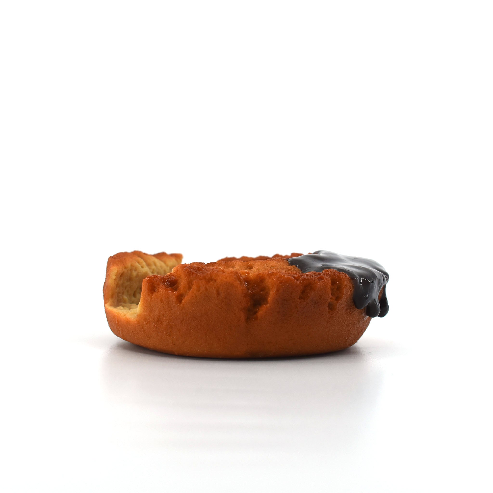 Side profile of a realistic donut-shaped phone holder with a bite mark and glossy chocolate glaze, placed on a clean white background.