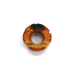 Hyperrealistic chocolate-glazed donut phone holder with a textured golden-brown finish and glossy topping, styled to look like a freshly baked old-fashioned donut.