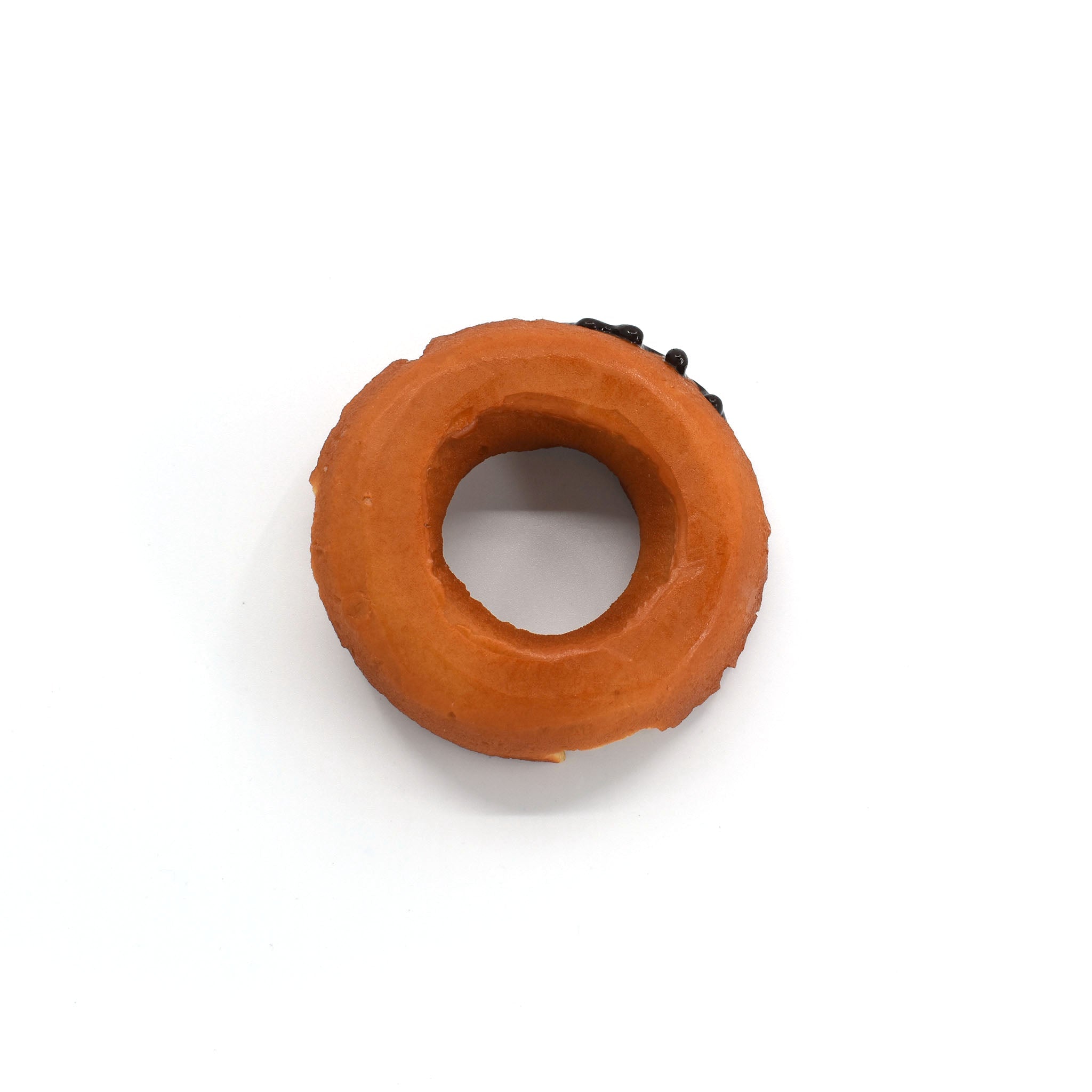 Top-down view of a realistic chocolate-glazed donut phone stand with a clean circular shape and visible icing on one side.