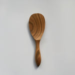 Sakura wood round rice paddle with curved handle, smooth carved bowl, and natural wood grain on a white background