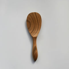 Sakura wood round rice paddle with curved handle, smooth carved bowl, and natural wood grain on a white background