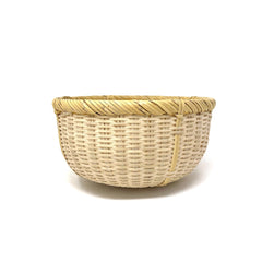 Handwoven Japanese bamboo basket with natural rim and tight pattern, perfect for mixing, rinsing vegetables, or countertop storage