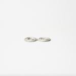 Flow Side angle of lightweight silver coil flower holder showing textured hammered surface and low profile design.