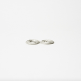 Flow Side angle of lightweight silver coil flower holder showing textured hammered surface and low profile design.