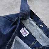 Close-up of Japanese denim shoulder bag interior showing pocket stitching, snap closure, and Three Lake Japan brand label