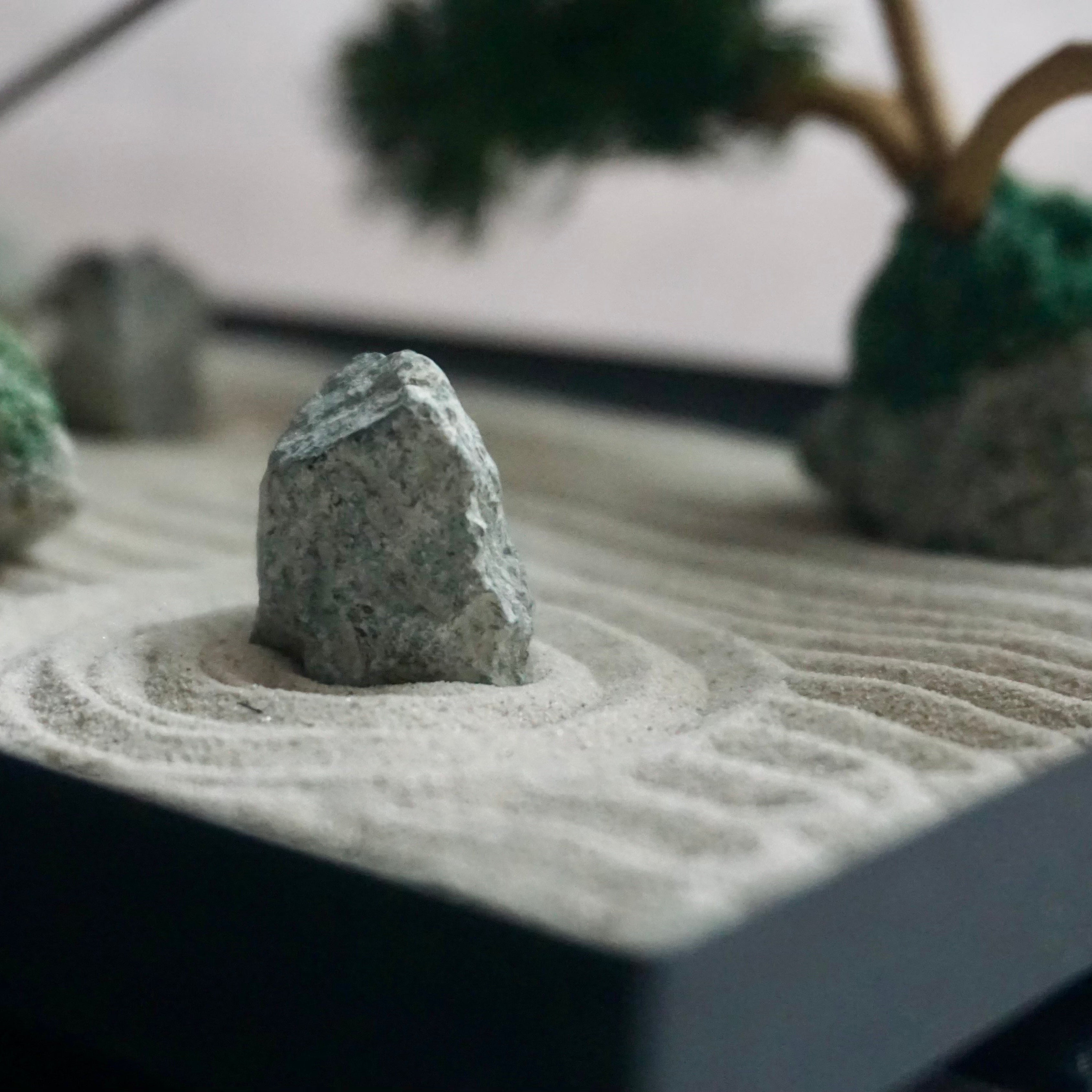 Detail view of stone and raked sand patterns in the Karesansui Zen Garden Incense Holder.