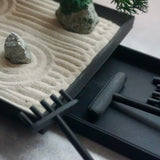 Close-up of miniature Karesansui Zen Garden Incense Holder showing raked sand, stones, and bamboo rakes.