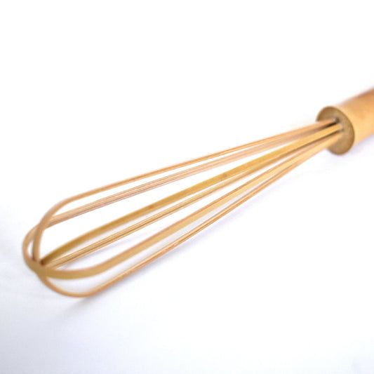 Close-up of handcrafted mini bamboo whisk with finely curved tines, ideal for whisking matcha, sauces, or rice vinegar—artisanally made in Japan.