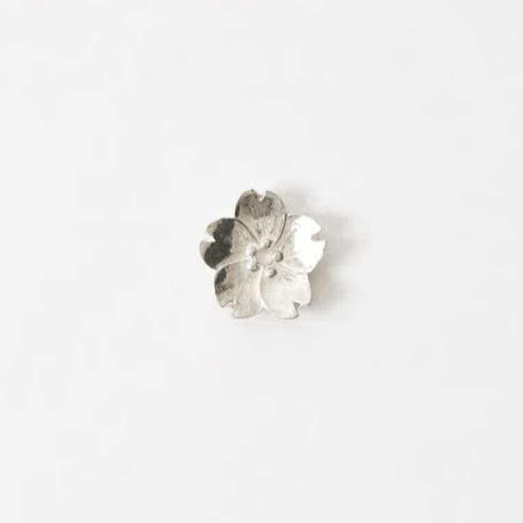 Sakura blossom-shaped pewter incense holder with five delicate petals, displayed on a plain white background.