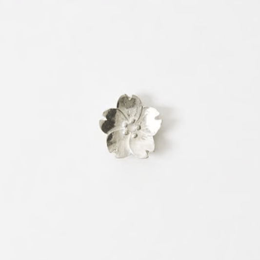 Sakura blossom-shaped pewter incense holder with five delicate petals, displayed on a plain white background.
