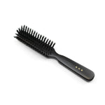Angled side view of a Kanaya natural bristle hair brush in medium firmness, featuring black bristles and a dark wooden handle with gold Japanese characters. Ideal for smoothing and styling with gentle tension.