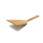 Side-angle close-up of a bamboo cooking turner showcasing its smooth bevel and gently curved ergonomic handle, emphasizing the precision-crafted edge ideal for sliding under delicate foods.