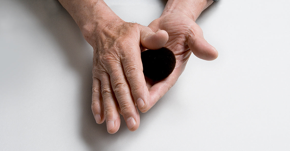 A Japanese artisan’s hands gently shaping a handcrafted Chikuhodo makeup brush, symbolizing precision, tradition, and care.