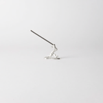 Chōjū-giga rabbit incense holder with incense stick inserted, handcrafted in pewter, capturing the dynamic motion of the leaping rabbit from Japan’s famous animal caricature scrolls.