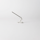 Chōjū-giga rabbit incense holder with incense stick inserted, handcrafted in pewter, capturing the dynamic motion of the leaping rabbit from Japan’s famous animal caricature scrolls.