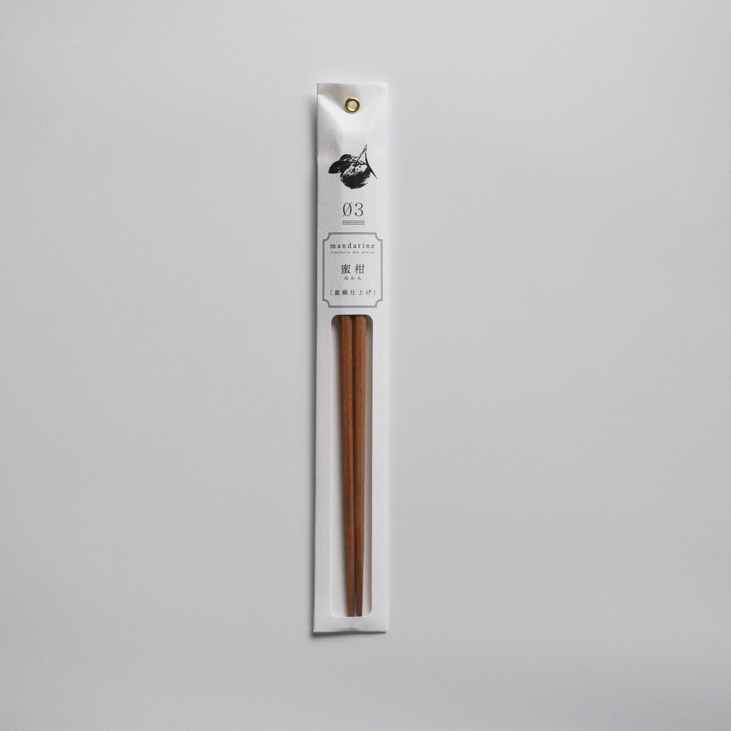 Mandarin wood chopsticks in sleek white packaging with botanical illustration.
