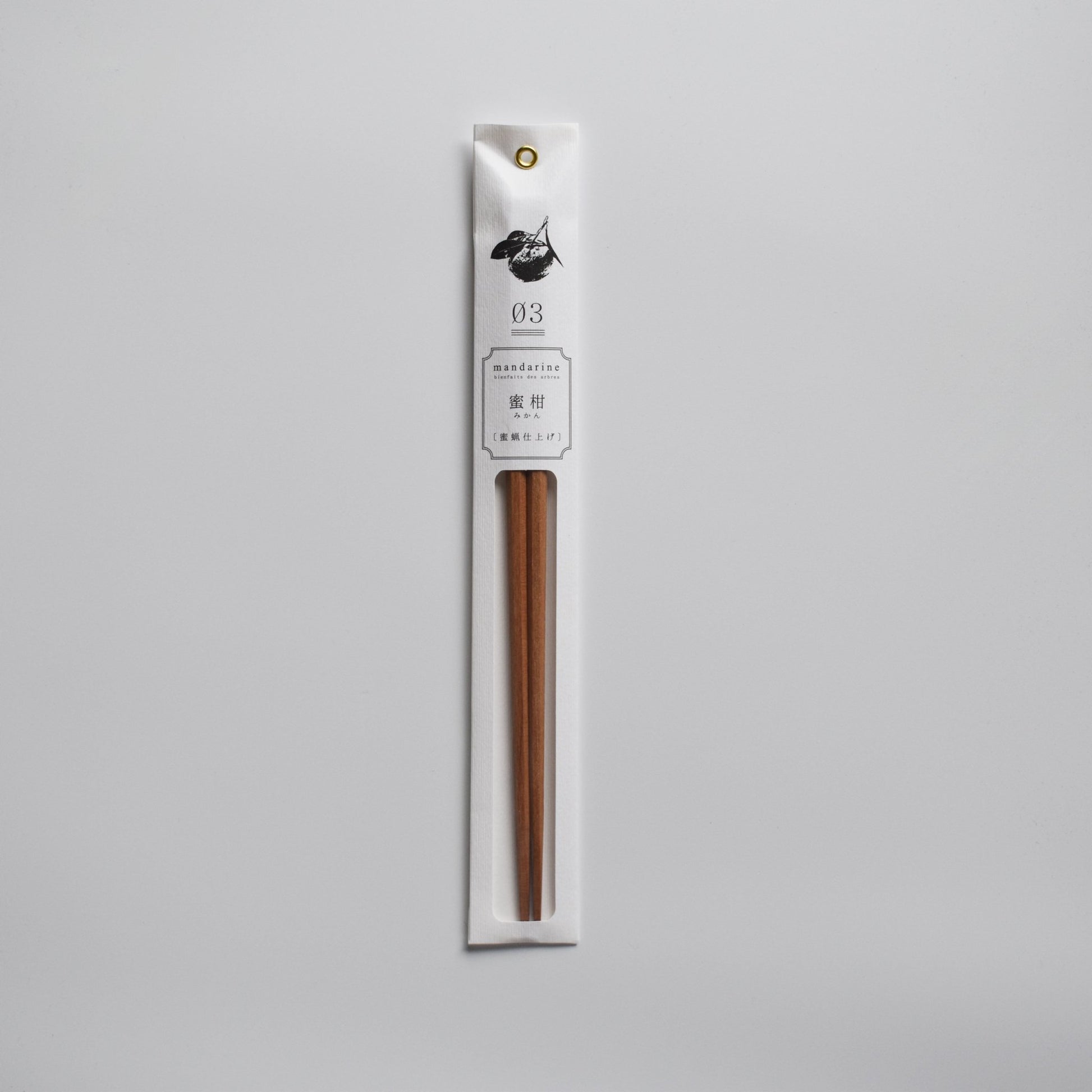 Mandarin wood chopsticks in sleek white packaging with botanical illustration.