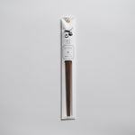 Persimmon wood chopsticks in minimalist white paper packaging with botanical illustration