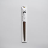 Persimmon wood chopsticks in minimalist white paper packaging with botanical illustration