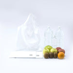 Cocoon Eco Bag fully unfolded and filled with groceries—fruits and large water bottles. Showcases its impressive strength and capacity despite its compact, lightweight design.