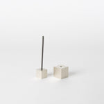 A minimalist silver cube incense holder with a clean, modern design, featuring one cube holding a thin incense stick while the other cube is displayed beside it on a white background, showcasing Japanese craftsmanship.