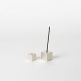 Silver cube incense holder set on a white background, with one cube holding a vertical incense stick and the other placed beside it, highlighting minimalist Japanese home decor aesthetics.