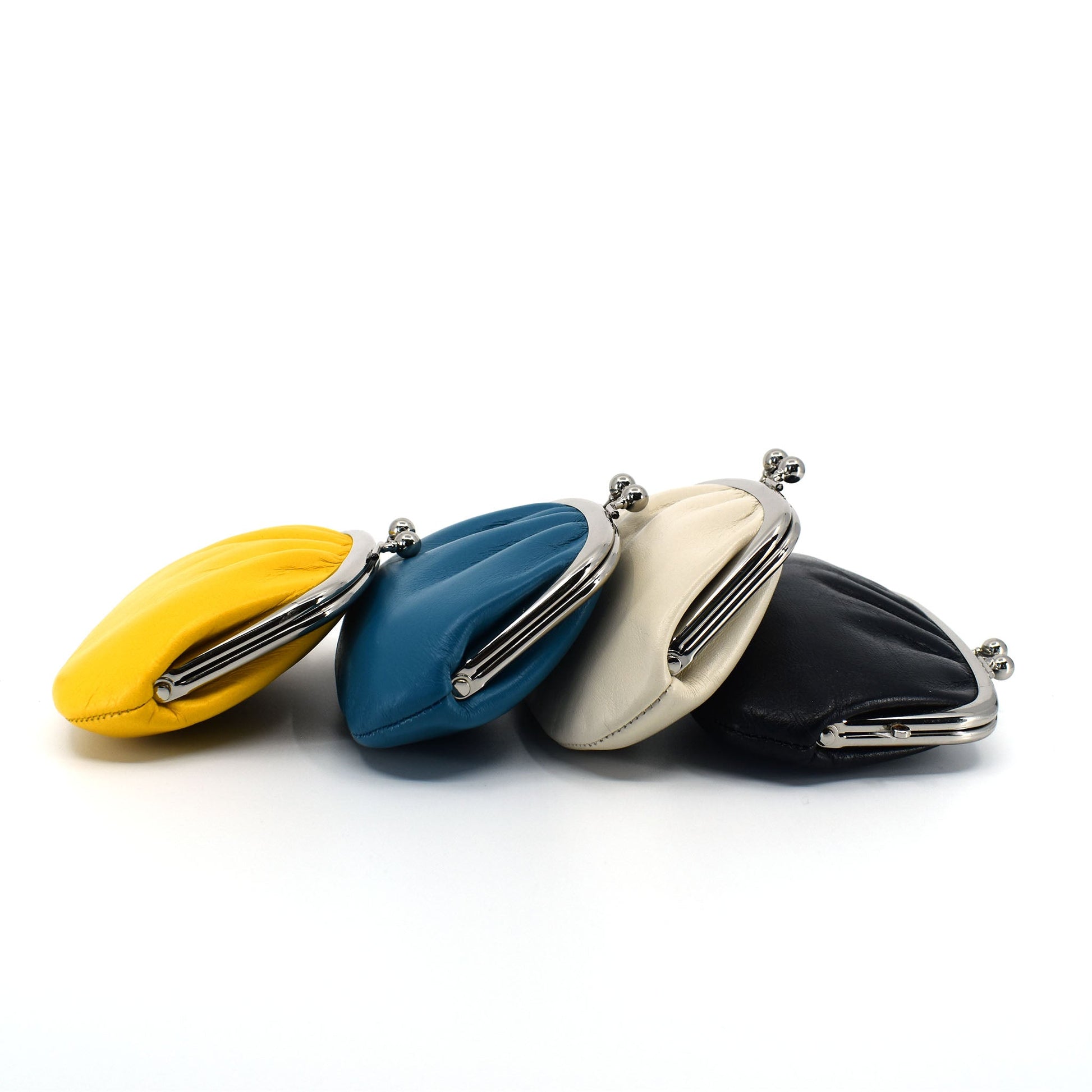 Set of four Japanese Gamaguchi leather coin purses in yellow, blue, ivory, and black, highlighting the full color range of the collection.