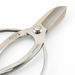 Close-up of the Hidehisa stainless steel floral shears, highlighting the engraved Japanese kanji on the polished handle and the precision-ground blade edge.