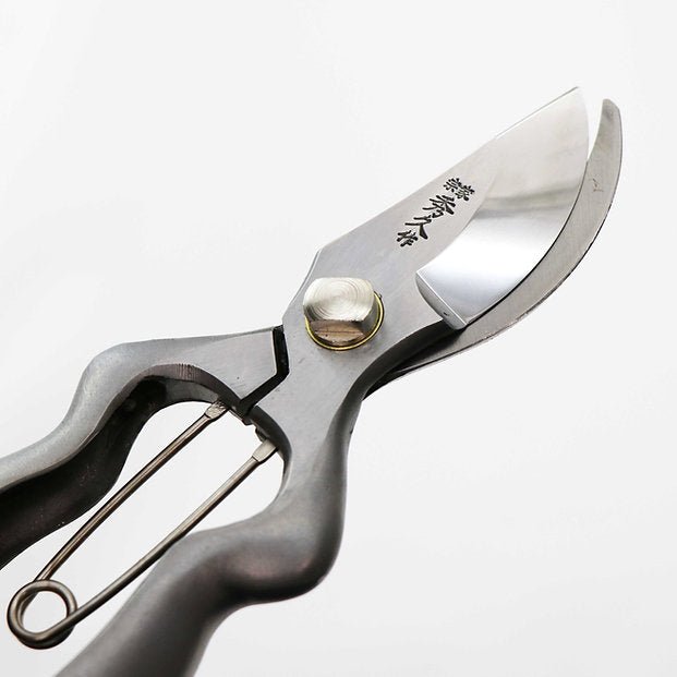 lade detail of Hidehisa stainless garden pruners with engraved Japanese kanji. 