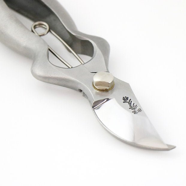Close-up of Hidehisa stainless garden pruners showing curved blade and engraved logo. 