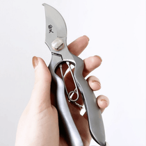 Hand holding Hidehisa stainless garden pruners – precision Japanese shears with curved blade and ergonomic grip