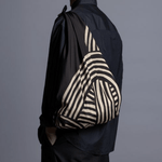 ISA Monyo Yui furoshiki in iron black tied as a shoulder bag, traditional Japanese wrapping cloth styled for everyday carry.