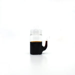 Japanese glass soy sauce dispenser with smooth drip-free spout, filled with soy sauce.