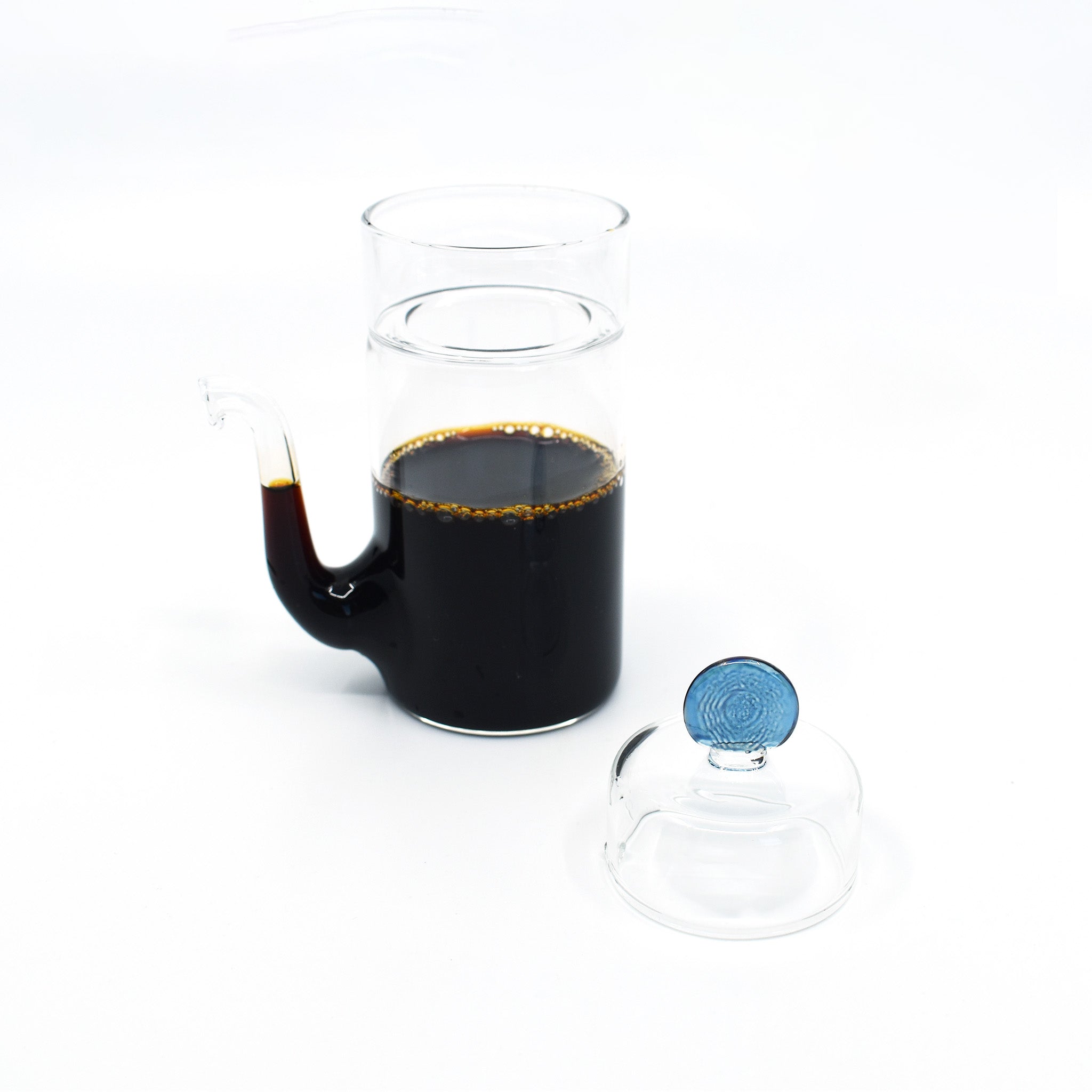 Japanese smooth pour glass soy sauce dispenser filled with soy sauce, shown with removable blue lid.