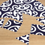 Close-up of a puzzle featuring traditional Japanese indigo and white wave pattern pieces spread across a wooden surface.
