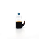 Front view of Japanese smooth pour glass soy sauce dispenser with drip-free spout and blue lid, filled with soy sauce.