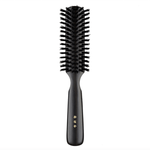Japanese round hair brush featuring firm black natural bristles and a polished dark wood handle, crafted for smooth detangling and everyday grooming.
